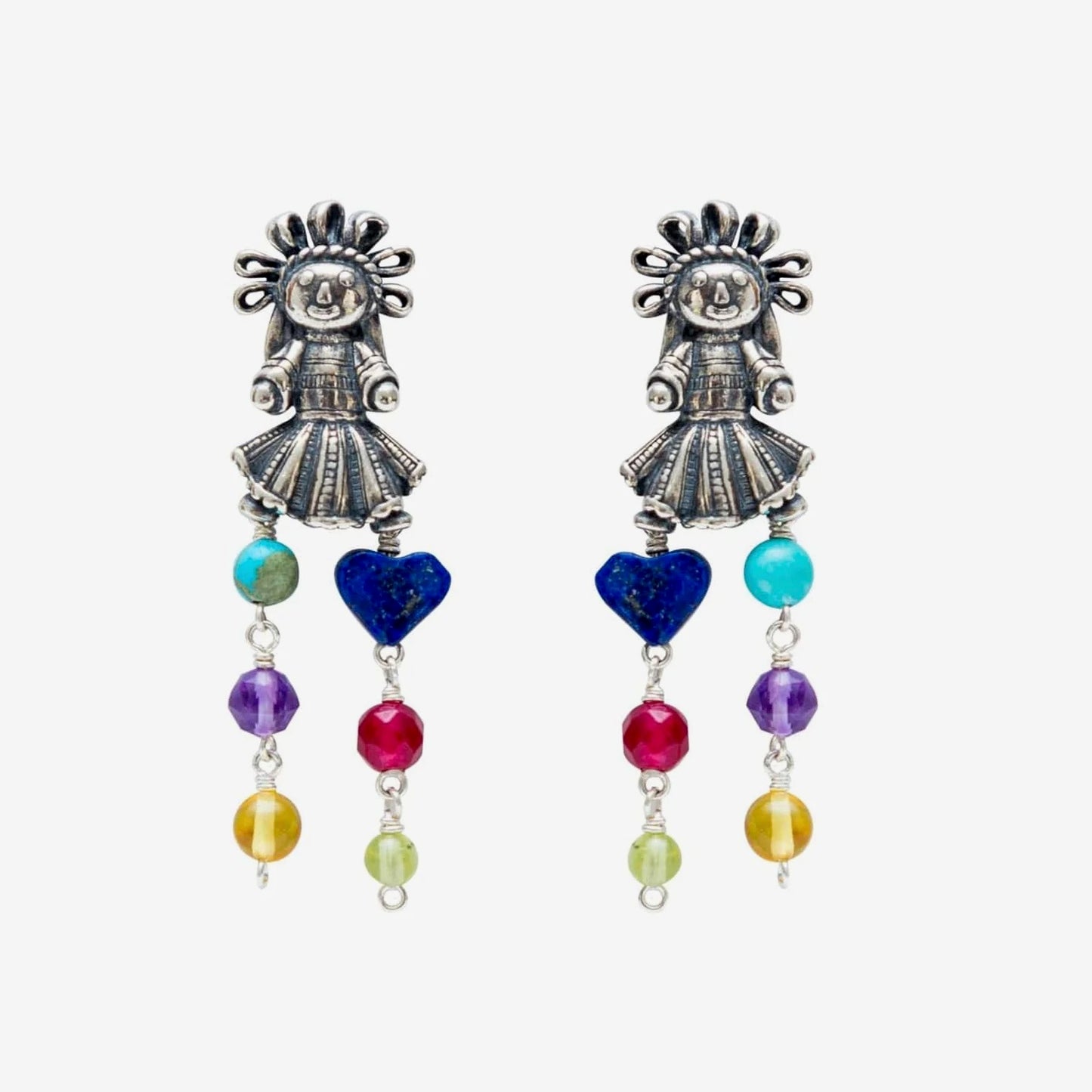 A pair of silver-toned dangle earrings featuring a stylized folk-art figure with sunburst hair, decorated with colorful beads including blue, turquoise, purple, red, yellow, and green on a light gray background.