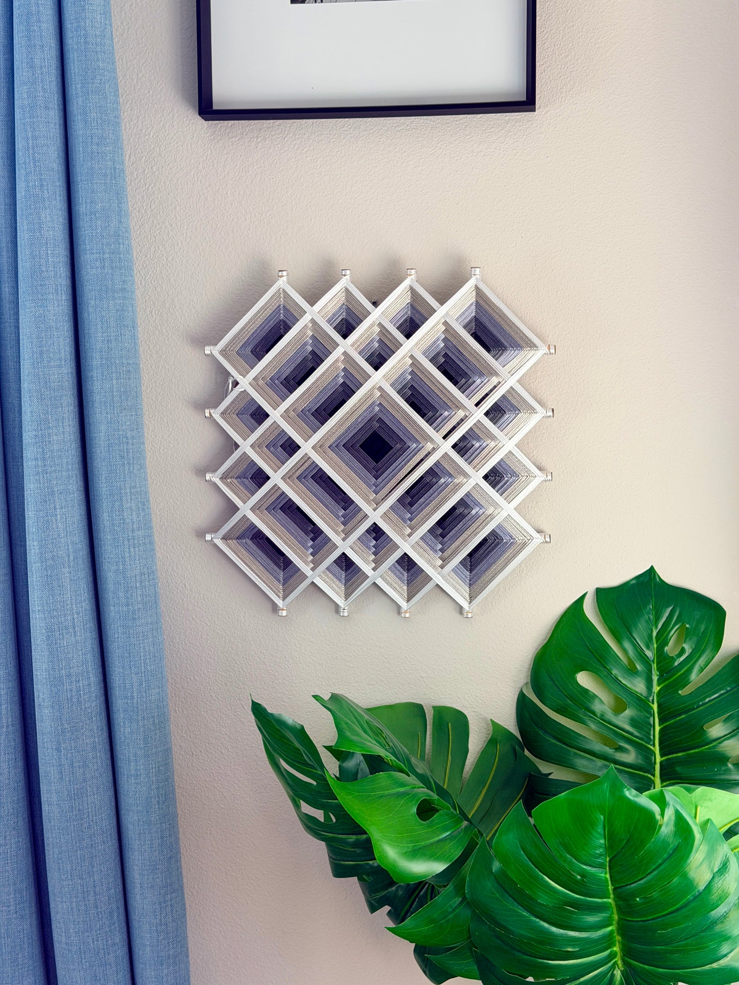 Contemporary Oaxacan fiber art mandala featuring layered geometric patterns in silver, gray, and white for meditation and living spaces.