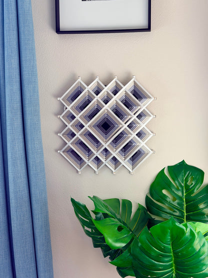 Contemporary Oaxacan fiber art mandala featuring layered geometric patterns in silver, gray, and white for meditation and living spaces.