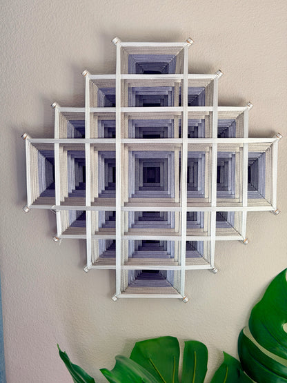 Contemporary Oaxacan fiber art mandala featuring layered geometric patterns in silver, gray, and white for meditation and living spaces
